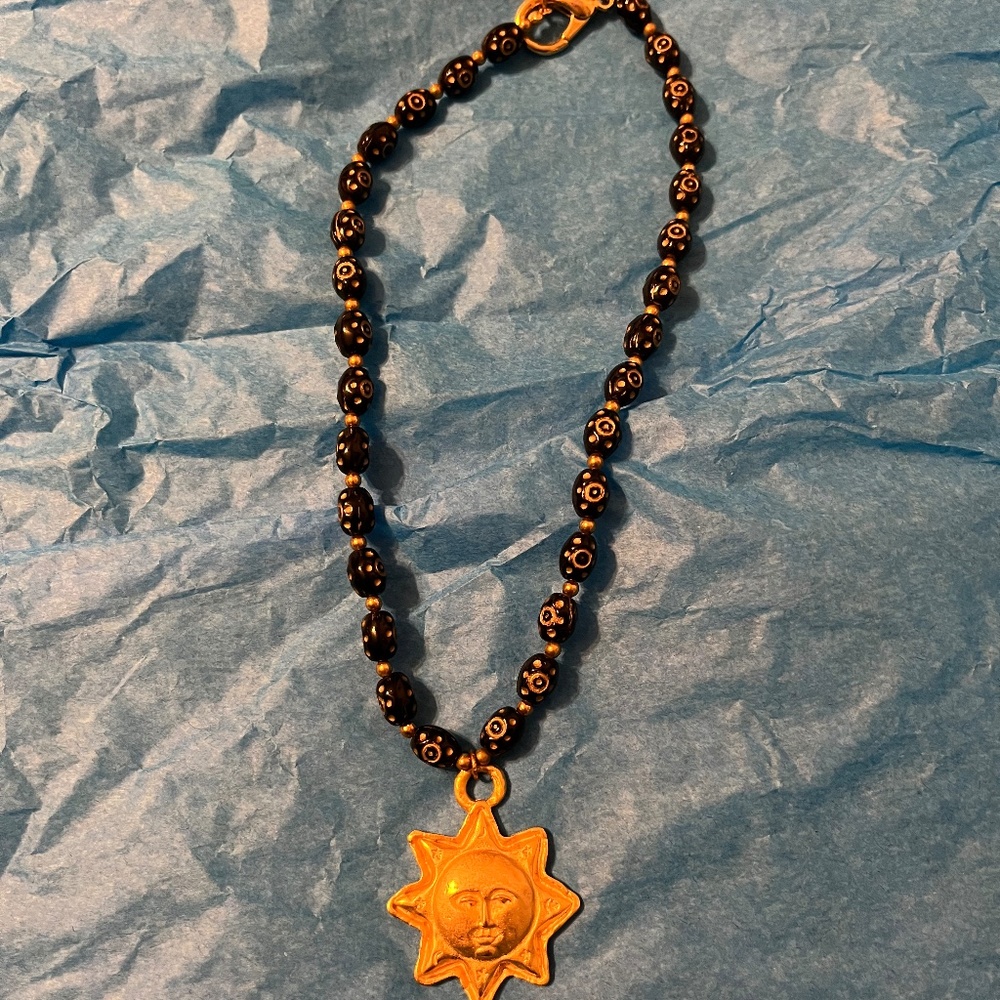 Necklace black/gold beaded with sun pendant. Chico’s, excellent condition.